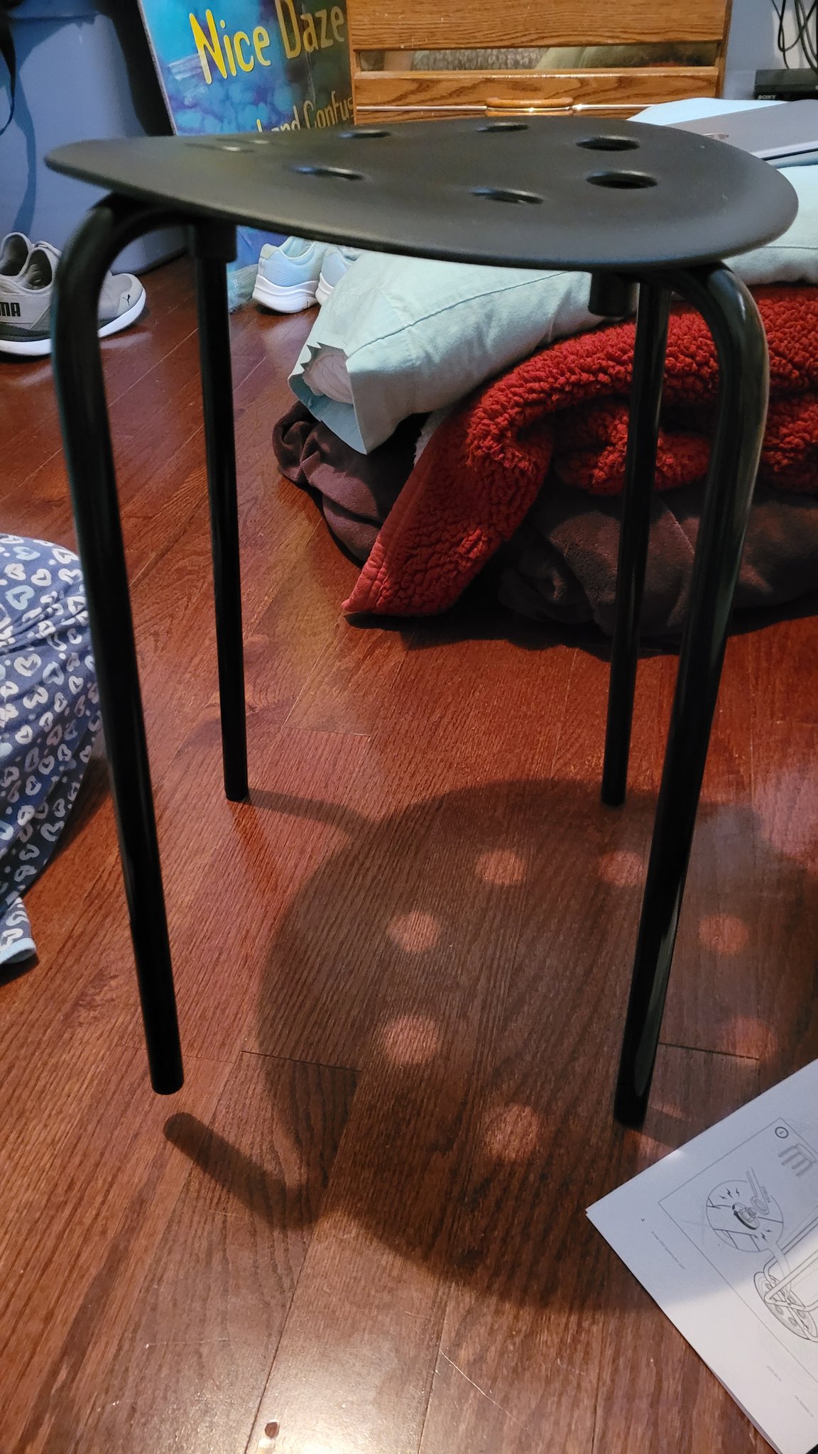 A very warped and poorly build black stool from IKEA