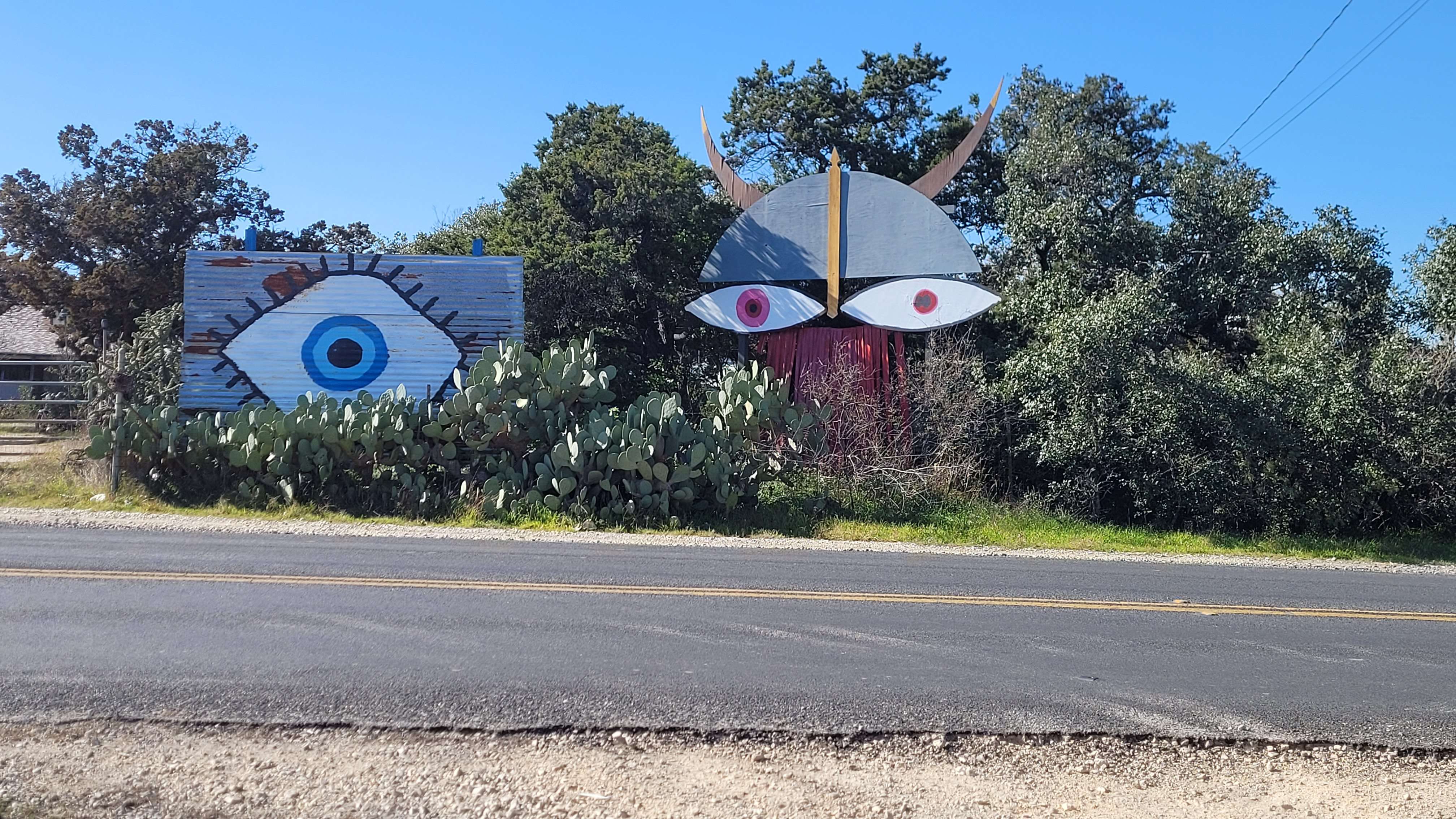 Two painted murals; one with a blue eye, and another as a viking with pink eyes, a grey helmet with horns, and a brown beard